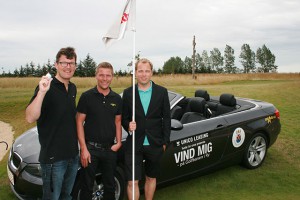 Kim Mortensen (tv) med bolden, der indbragte ham en hole in one og en måneds fir kørsel i en BMW 325 D Cabriolet. I midten Morten Revsbæk fra Unia Auto og til højre Jeppe Andersen fra Unico Leasing. Foto: Per Pedersen